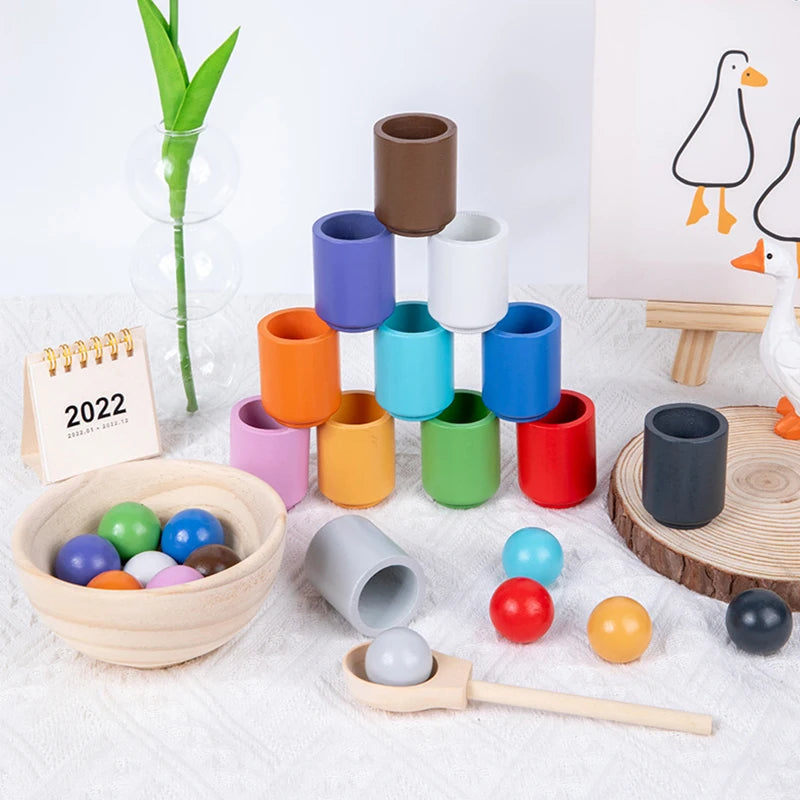 Enhance your child's fine motor skills, cognitive development, and colour recognition with our Montessori Wooden Balls in Cups Sorter. This educational toy includes 12 wooden balls, 12 cups, a bowl, a spoon, and a storage bag. Perfect for ages 3+, it promotes sequencing, problem-solving, and imaginative play. Made from high-quality, non-toxic wood for safe play.