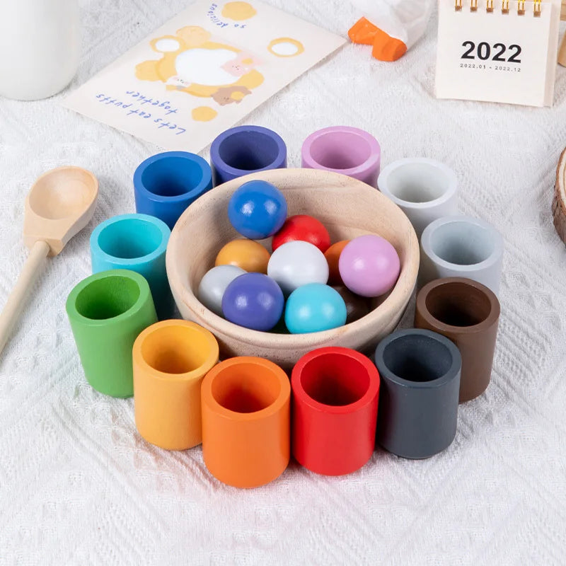 Enhance your child's fine motor skills, cognitive development, and colour recognition with our Montessori Wooden Balls in Cups Sorter. This educational toy includes 12 wooden balls, 12 cups, a bowl, a spoon, and a storage bag. Perfect for ages 3+, it promotes sequencing, problem-solving, and imaginative play. Made from high-quality, non-toxic wood for safe play.